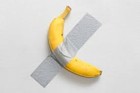 "Banana duct-taped to a wall, conceptual artwork by Maurizio Cattelan titled Comedian, highlighting themes of value and impermanence in contemporary art."